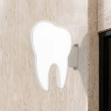 Dental clinic sign in the shape of a tooth